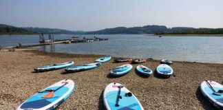 Paddleboards by the shore of a reservoir