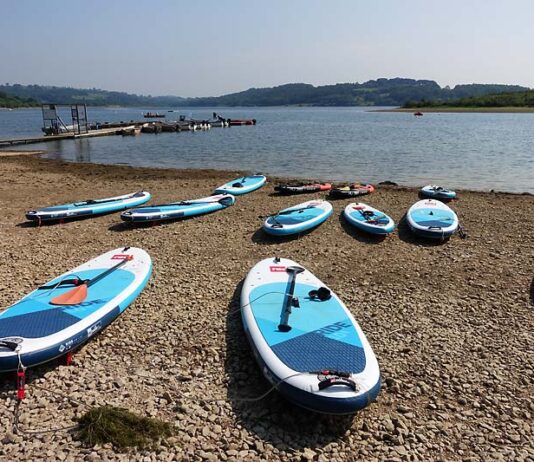 Paddleboards by the shore of a reservoir
