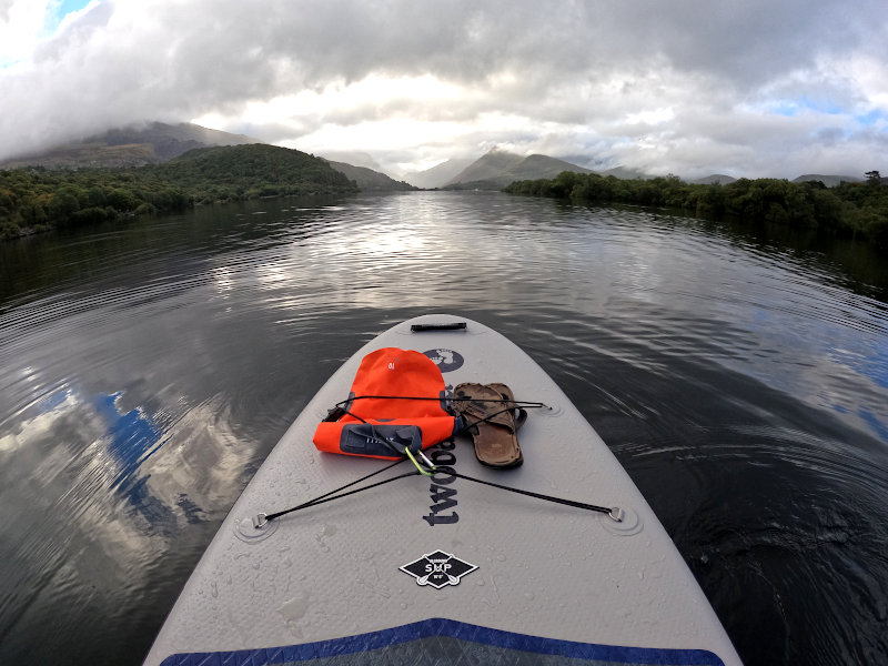 Paddle Board deck with dry bag stashed under bungee cord