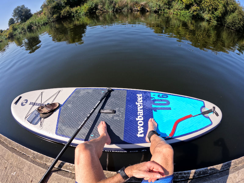 About to launch paddle board in river